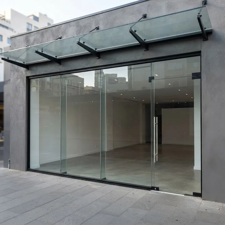 Illustrative complete frameless doors shop front: Right Pivot Entry, right entrance with three narrow display bays, frameless glass with metal hardware.